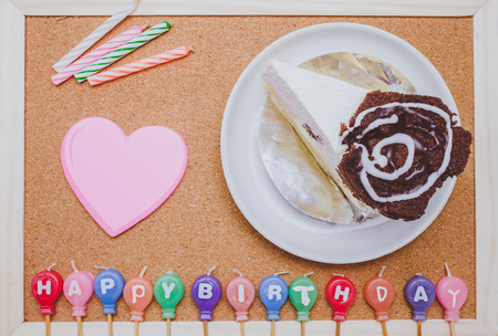 Cake,colorful Birth day candles and post it on cork board backgroundの写真素材
