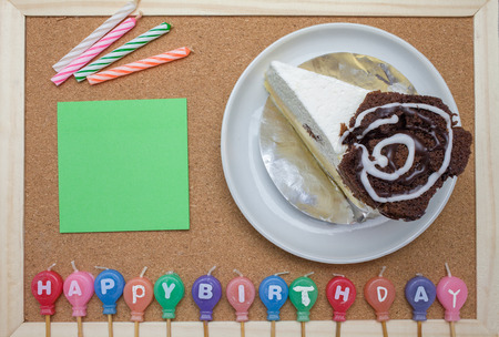 Cake,colorful Birth day candles and post it on cork board backgroundの写真素材