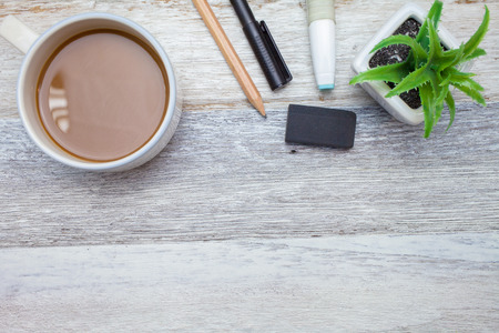 Brownie cheese cake,pen,pencil and coffee on wooden background