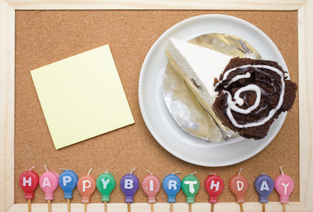 Cake,colorful candles and post it on cork board backgroundの写真素材