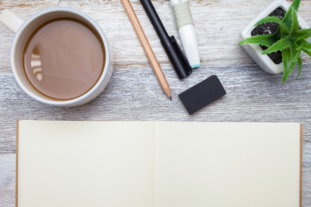Brownie cheese cake,pen,book,pencil and coffee on wooden backgroundの写真素材
