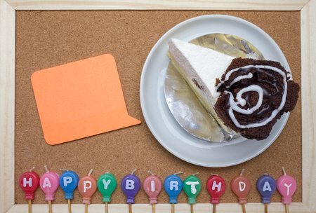 Cake,colorful Birth day candles and post it on cork board backgroundの写真素材