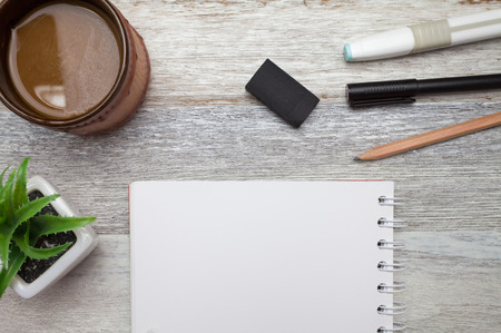 Brownie cheese cake,pen,book,pencil and coffee on wooden backgroundの写真素材