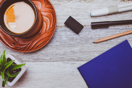 Brownie cheese cake,pen,pencil and coffee on wooden backgroundの写真素材