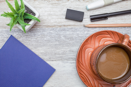 pen,book,pencil and coffee on wooden backgroundの写真素材