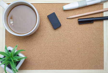 Plant,Pen,book,pencil and coffee on cork board backgroundの写真素材