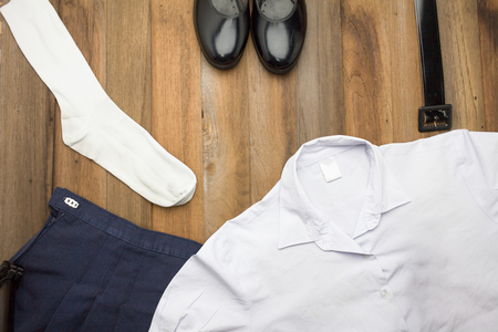 Still life : Thai Student girl uniform with wooden background on top viewの写真素材