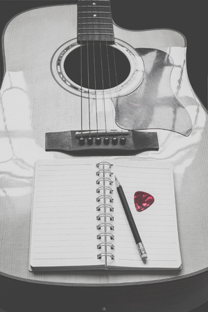 guitar,pencil and scrapbook ,Writing music in vintage toneの写真素材