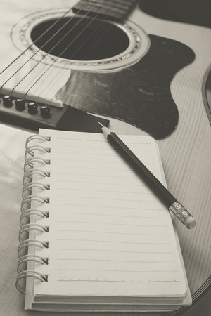 guitar,pencil and scrapbook ,Writing music in vintage toneの写真素材