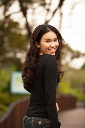 Thai pretty girl jumping and waving hair with a moment happiness.の写真素材