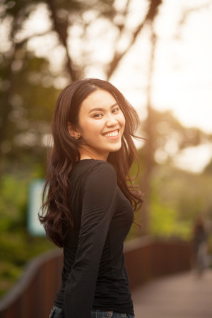 Thai pretty girl jumping and waving hair with a moment happiness.の写真素材