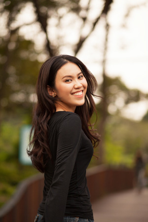 Thai pretty girl jumping and waving hair with a moment happiness.の写真素材