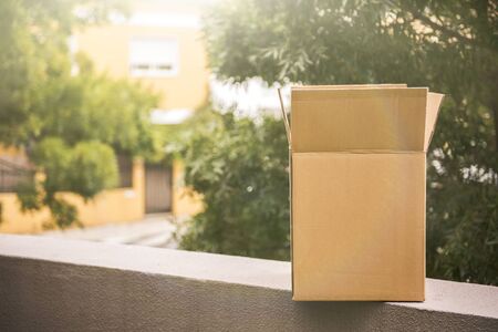 Cardboard moving big box near house