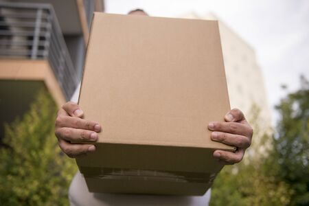 Man Holds Carton Box In Hands, shipping delivery box in hands, carton package.の写真素材