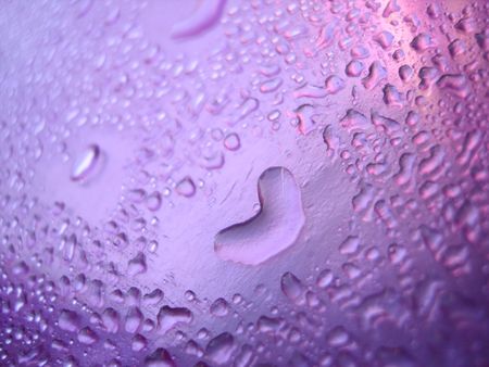Pink water drop with heartの写真素材