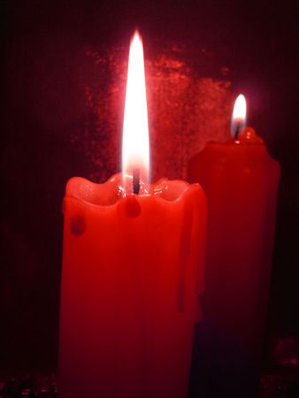 Two red candles in darknessの写真素材