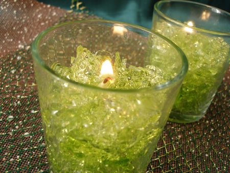 Beautiful green candlesticks over colored backgroundの写真素材