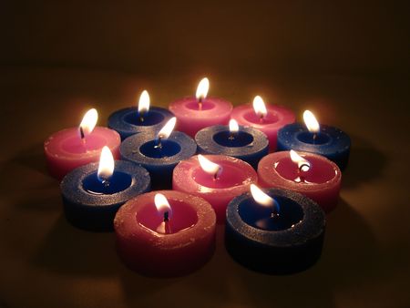 many blue and pink candles in darkness  の写真素材