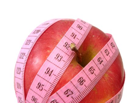 apple with pink tape measure over white background (concept of health, diet) の写真素材