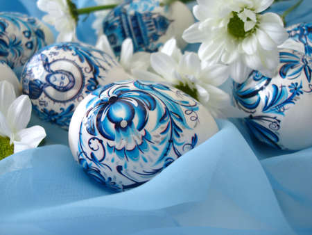 beautiful blue easter eggs with white flowers の写真素材