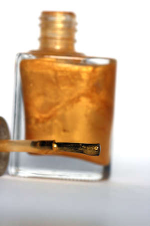 golden nail polish, focus on brush の写真素材