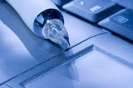 pen and computer keyboard on blue colour の写真素材