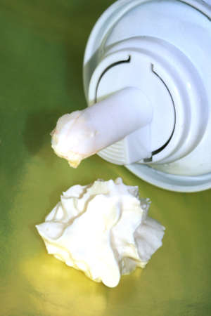 bottle with cream on yellow background 