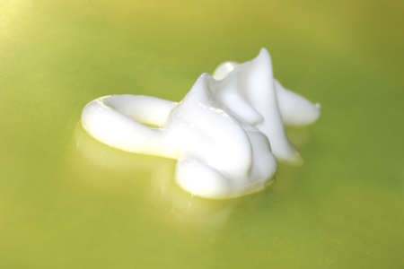 shampoo or cream on yellow background 