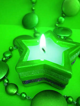 green star candle on celebration background の写真素材
