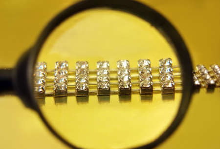 find the diamond necklace with magnifying glass の写真素材