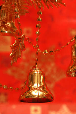 new-year handbells and Christmas tree on red background の写真素材