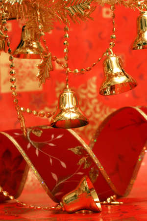 new-year handbells and Christmas tree on red background の写真素材