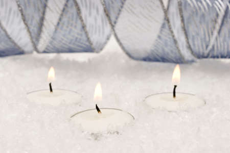 festive new-year candles with snow の写真素材