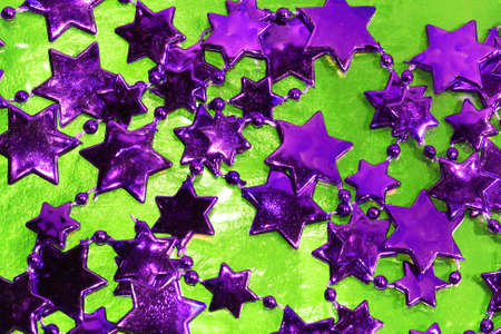 violet Christmas stars on green background の写真素材