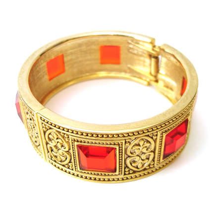 Close-up of golden bracelet isolated on white background の写真素材