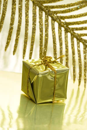 gift box on golden background with leaf の写真素材