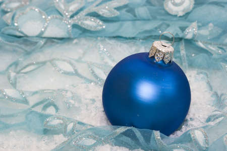 blue Christmas ball on snow background の写真素材