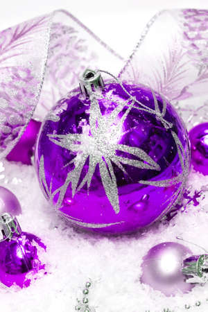 violet festive decoration on snow の写真素材