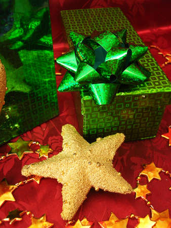 green gift box and golden star on celebration background の写真素材