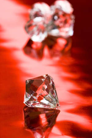 beautiful diamond crystal on red background の写真素材