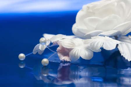 white artificial wedding flowers on blue の写真素材