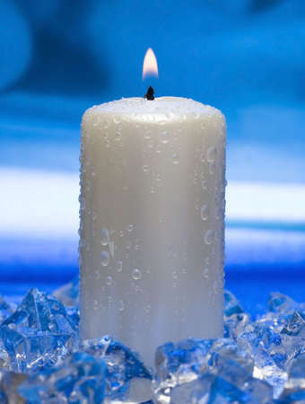 candle with ice on blue background の写真素材