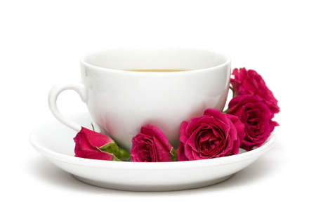 white cup of coffee with red roses の写真素材