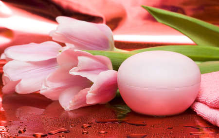 cream, towel with flowers on red background の写真素材