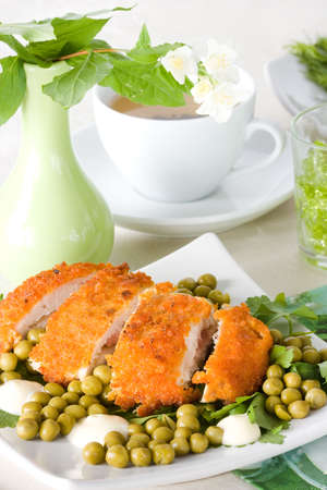 Chicken meat with pea and cup of tea の写真素材