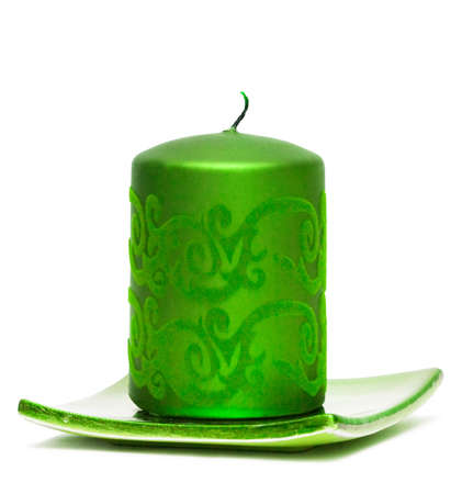 green burning candle on white background の写真素材