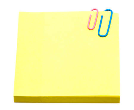 yellow pages of notebook with paper clip on white 