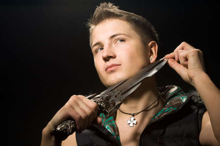 man shaves oneself with dagger の写真素材