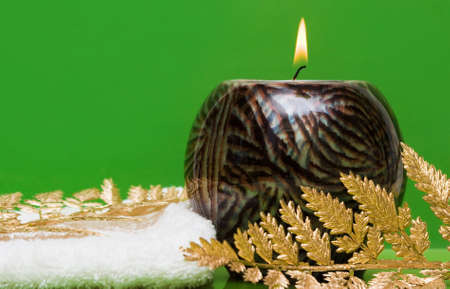 candle with towel and decorative leaves の写真素材