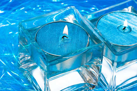 blue candles in glass with water の写真素材